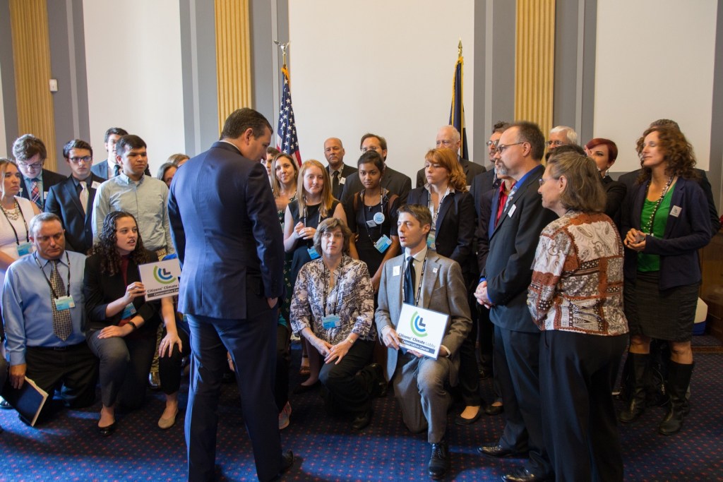 Peter Bryn the leader of the conservatives’ action team is presenting our carbon fee and dividend proposal to Senator Ted Cruz in 2017. Ted Cruz is turned away from the camera facing Peter Bryn. The CCL Texas delegation (about 30 people) is standing in the background.