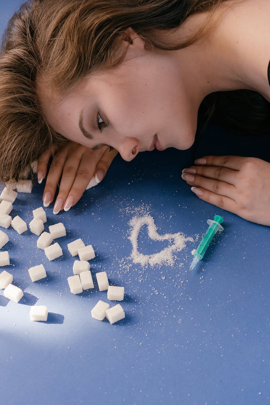 Photo of woman lying on the floor surrounded by sugar.