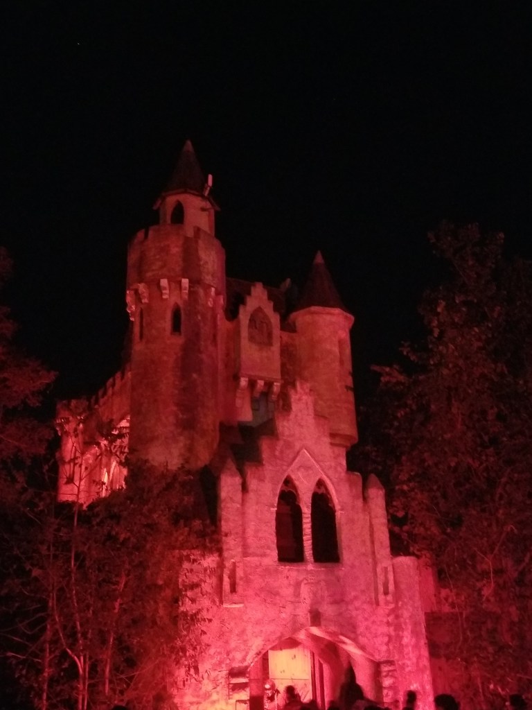 A dimly lit castle that looks like the Bran castle in Transylvania.