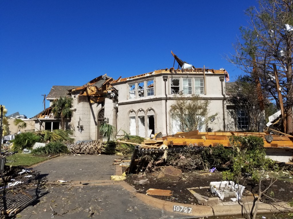 A big nice-looking house destroyed by a tornado.