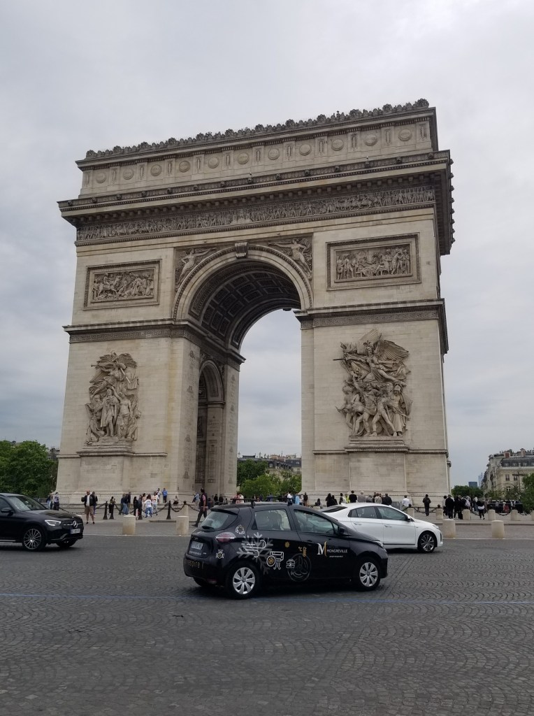 The photo shows Arc de Triomphe and the circulation place around it.