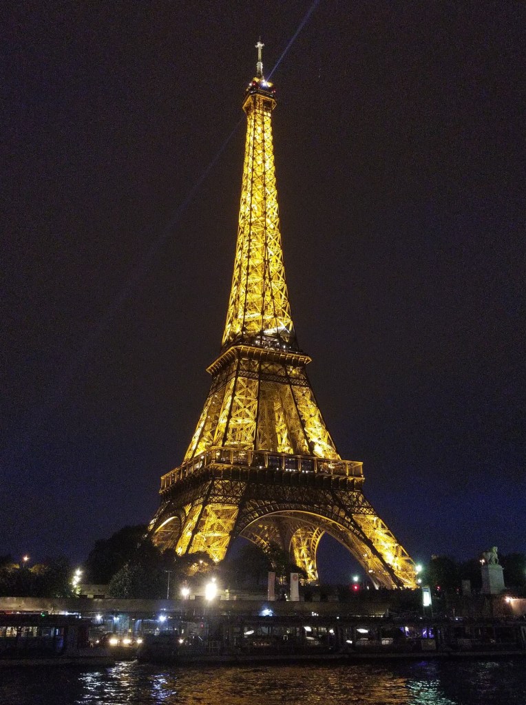 Photo of the Eiffel Tower at night. It is lit up by 20,000 LED lights.