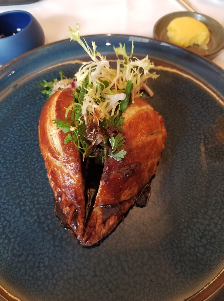 The shape of the Pigeon on my plate at Violin d’Ingres is like that of small whole chicken. It is garnished with arugula and other greens.