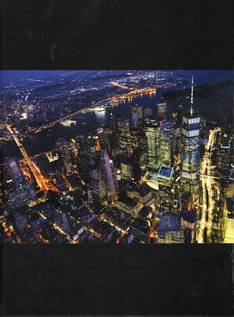 The front cover features a colorful nighttime photo of Manhattan from above.