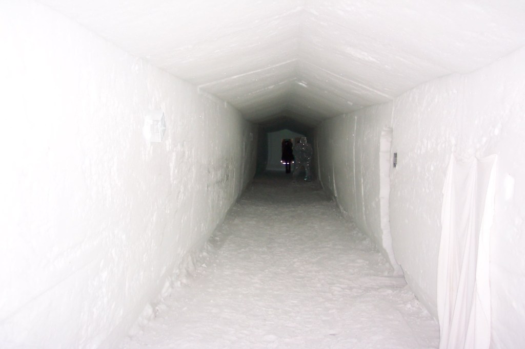 A long white icy hallway in the darkness.
