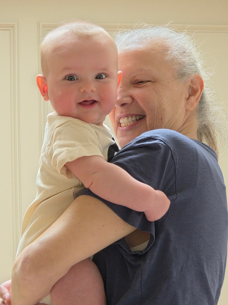 My wife is holding a very happy baby Jack.