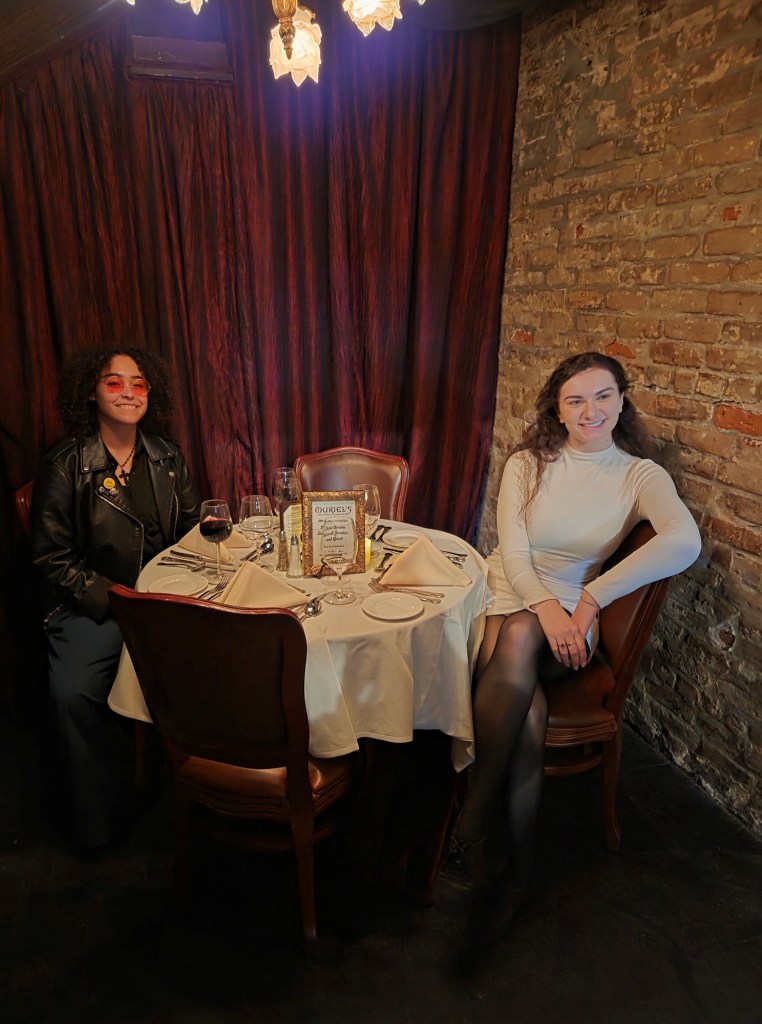 It is a photo of a table that is already set. There is an empty chair between my daughter and my son’s girlfriend.