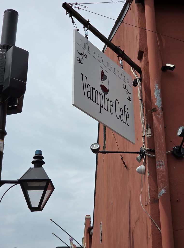 A  white sign stating Vampire Café.