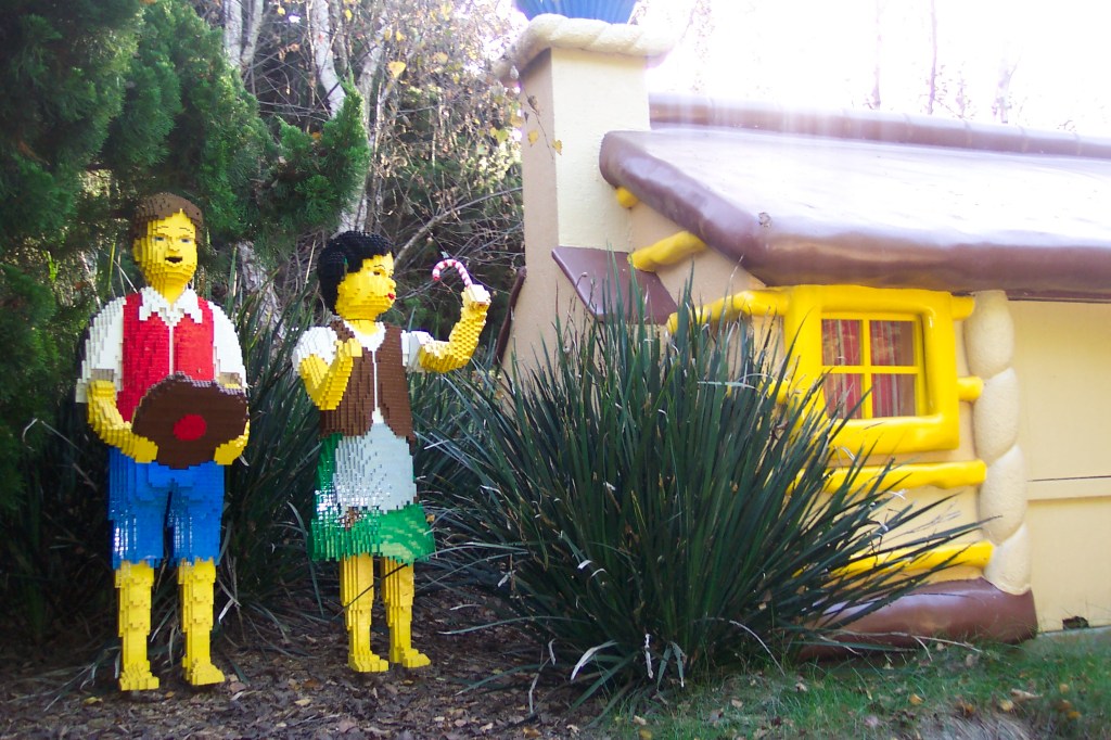 Hans and Gretel is standing next to a house, probably the witches house.