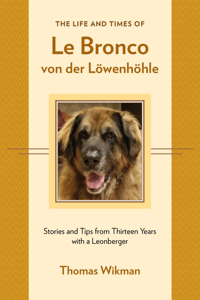 The gold and beige book cover features the face of our Leonberger Bronco and the text "The Life and Times of Le Bronco von der Löwenhöhle. Stories and Tips from Thirteen Years with a Leonberger."
