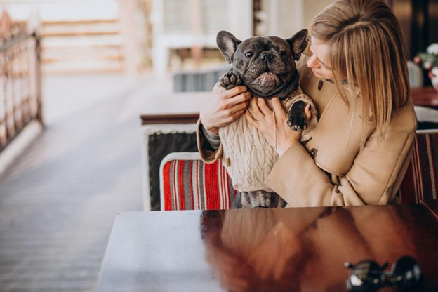 Woman with a dog in a pet bakery.